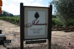 Framed MDO with 

3-D carved urathane "grapes" and "name" components, on stained posts.