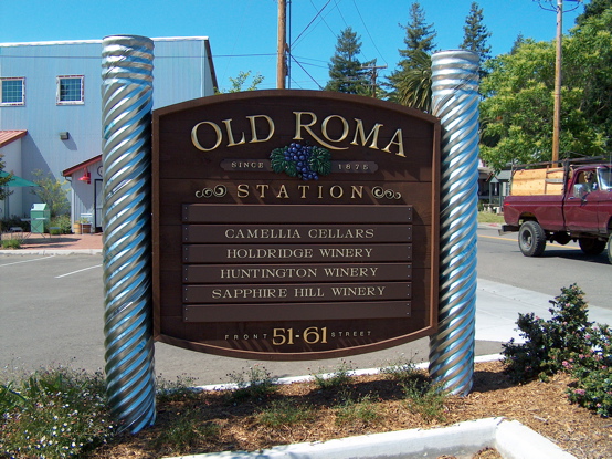 Old Roma redwood monument with 3D urathane letters covered in 23K gold leaf and carved grape cluster.  This sign is awesome and stands out wonderfully, the picture does it no justice