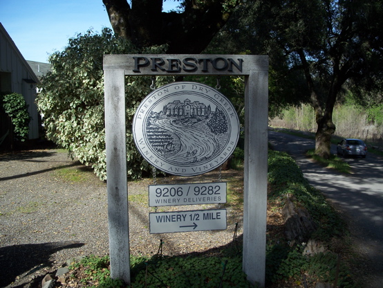 Preston stained cutout redwood letters and hand painted graphic on rustic posts designed to have a very rustic look
