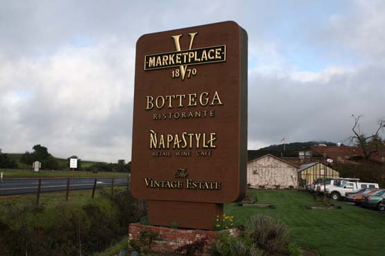 Existing monument that we re-faced with rough siding & solid stain.  Logos are 3-D urathane with 23K gold