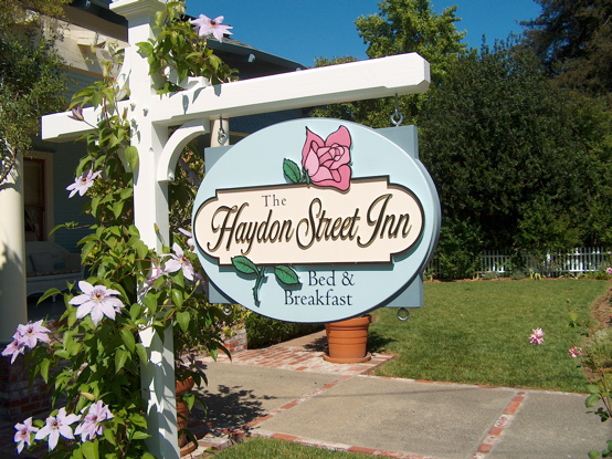 This simple sign was designed by us and is 2d carved from urathane.  It's now almost 10 years old and looks 

almost as good as it did the day we hung it.