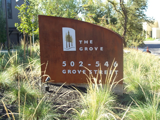 Core-ten steel purposely rusted, with 1/4" brushed aluminum copy and graphic.  We also 

poured the engineered concrete base