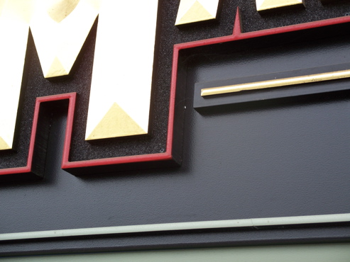 Convex urathane letter with gold leaf. The black border is 

"smalt" (cut glass)